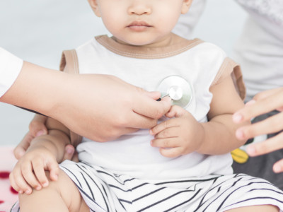 Toddler being checked out by physician