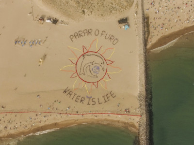 On August 4, about 800 people gathered at a beach near Lisbon, Portugal, to form a giant message saying, "Stop the oil drilling" and "Water is life."