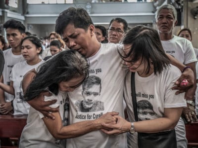 Mourners take part in the funeral of Jhan Cyrell Ignacio, a college freshman who was killed by unidentified gunmen, in Malabon, Metro Manila, in the Philippines on July 14, 2018. More than 27,000 have been killed as a result of a two-year war on drugs in the Philippines.