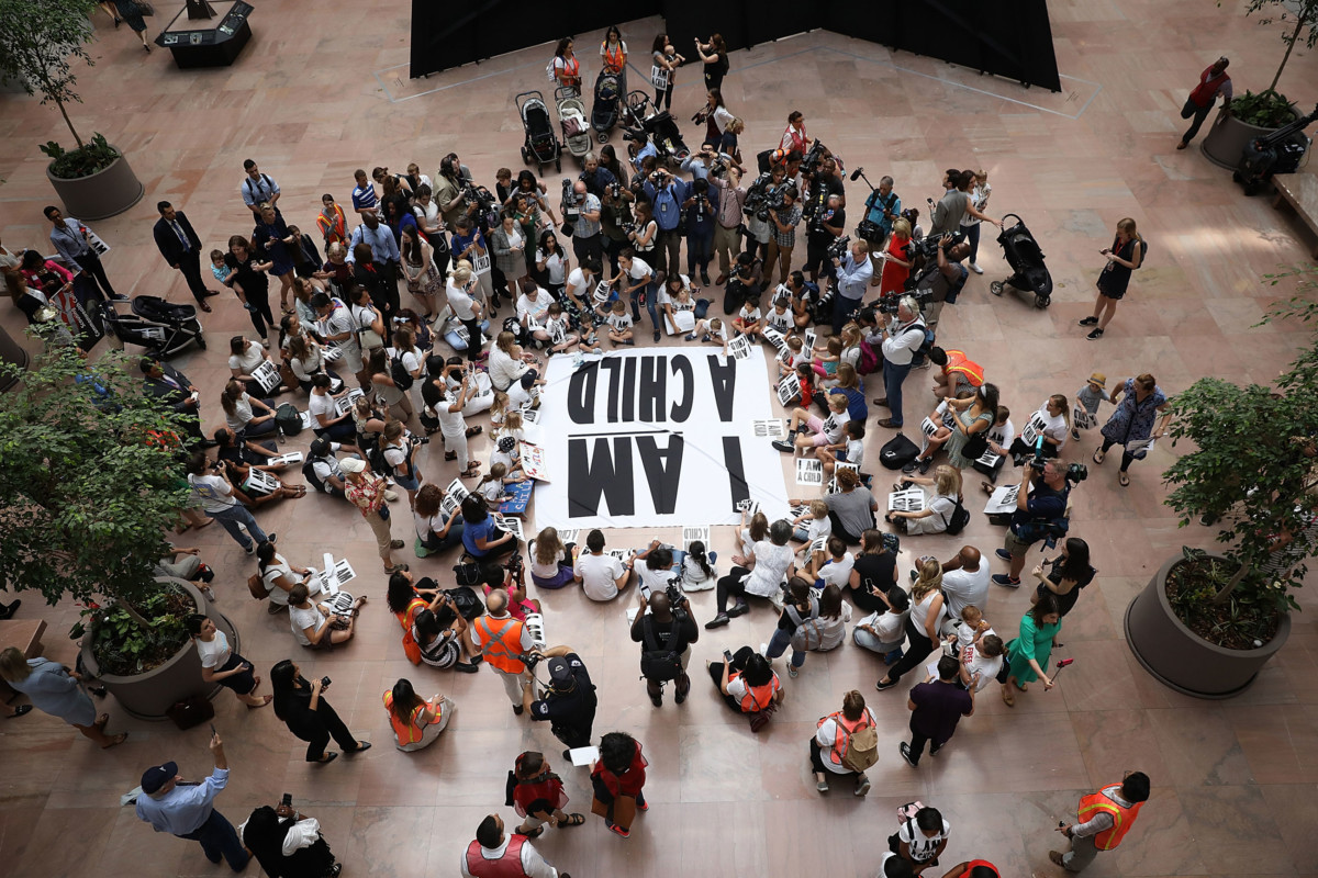 Protesters and their children participate in a sit-in in the Hart Senate Office Building to mark the court-ordered deadline for the Trump Administration to reunify thousands of families separated at the border July 26, 2018, in Washington, DC.