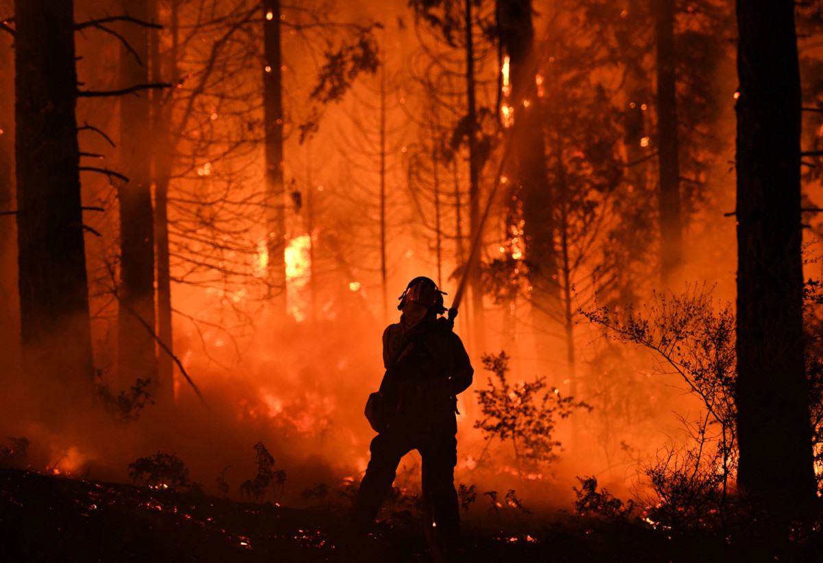 A firefighter tries to control a back burn as the Carr fire continues to spread towards the towns of Douglas City and Lewiston near Redding, California, on July 31, 2018.