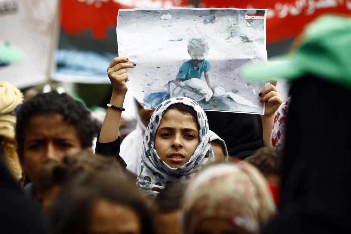 A Yemeni girl raises a poster during a demonstration in Sanaa on August 12, 2018, against an airstrike by the Saudi-led coalition that hit a bus, killing dozens of children in the northern Huthi stronghold of Saada.
