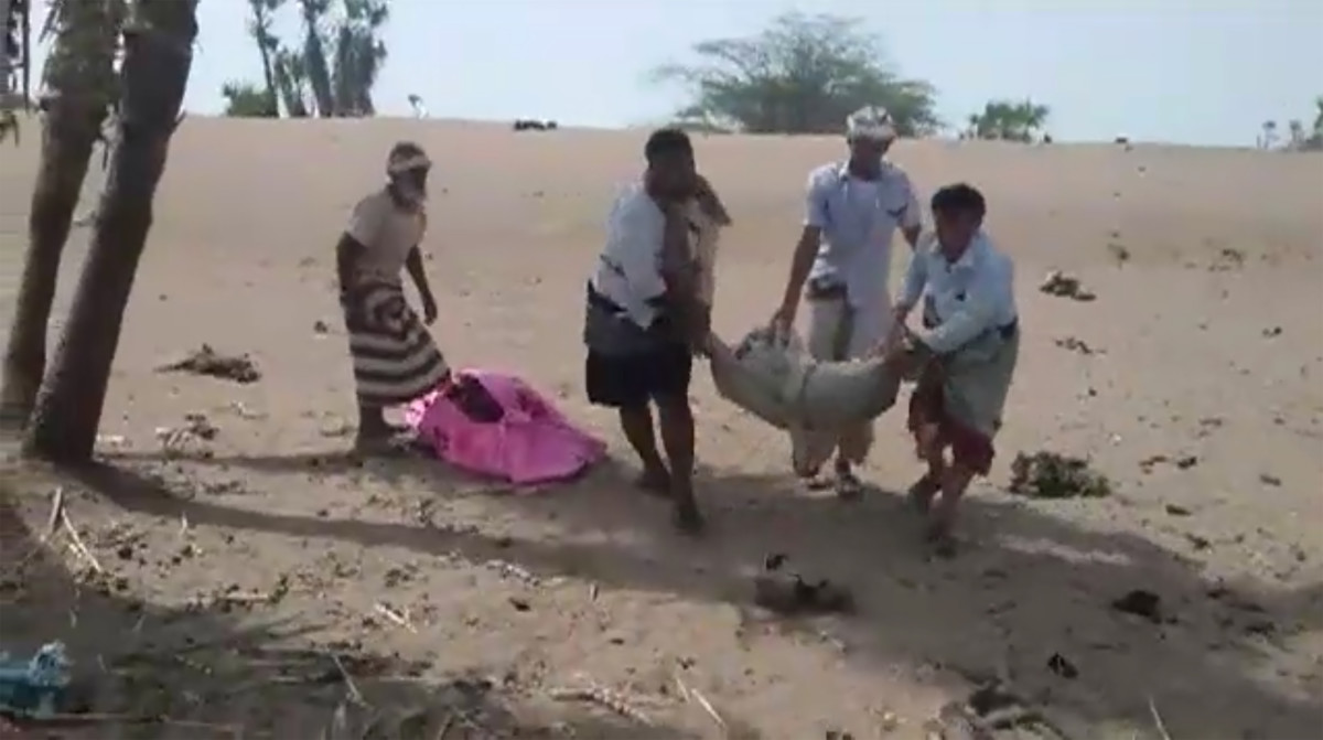 A grab taken from a AFPTV video on August 25, 2018 shows men carrying covered bodies in Al-Durayhimi, some 20 kilometers (12 miles) south of Hodeida, after a missile strike for which the Houthi rebels and a Saudi-led coalition fighting them traded blame.