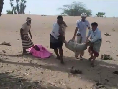 A grab taken from a AFPTV video on August 25, 2018 shows men carrying covered bodies in Al-Durayhimi, some 20 kilometers (12 miles) south of Hodeida, after a missile strike for which the Houthi rebels and a Saudi-led coalition fighting them traded blame.