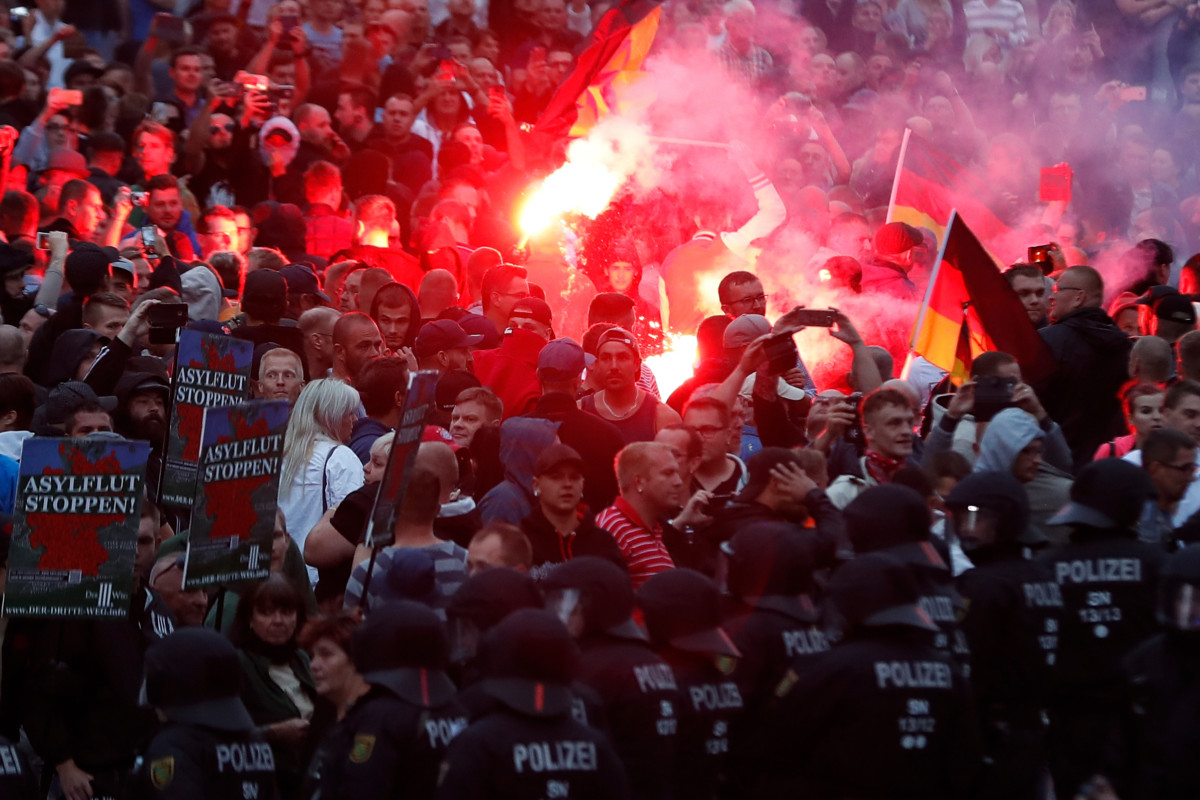 Right-wing demonstrators light flares on August 27, 2018, in Chemnitz, eastern Germany, following the death of a 35-year-old German national who died in a hospital after a "dispute between several people of different nationalities," according to the police.