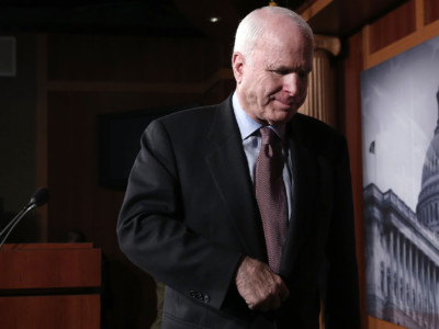 Senator John McCain leaves after a news conference on Capitol Hill in Washington, DC, on February 14, 2013.