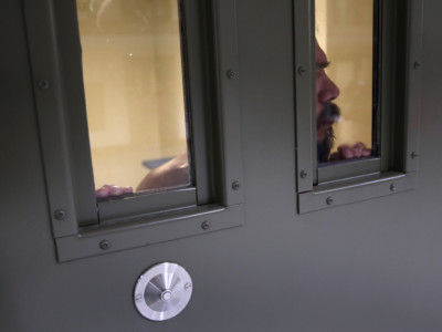 An immigrant detainee looks from his segregation cell at the GEO Group Adelanto detention jail on November 15, 2013, in Adelanto, California.