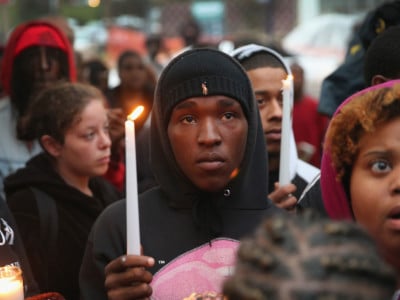 Mourners attend a candlelight vigil in memory of 18-year-old Vonderrit Myers Jr. on October 9, 2014, in St. Louis, Missouri. Meyers was shot and killed by an off-duty St. Louis police officer.
