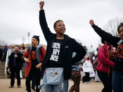 Black lives matter protesters chant in the middle of the student quad during a protest against education cuts at Chicago State University in Chicago, Illinois, on April 1, 2016.