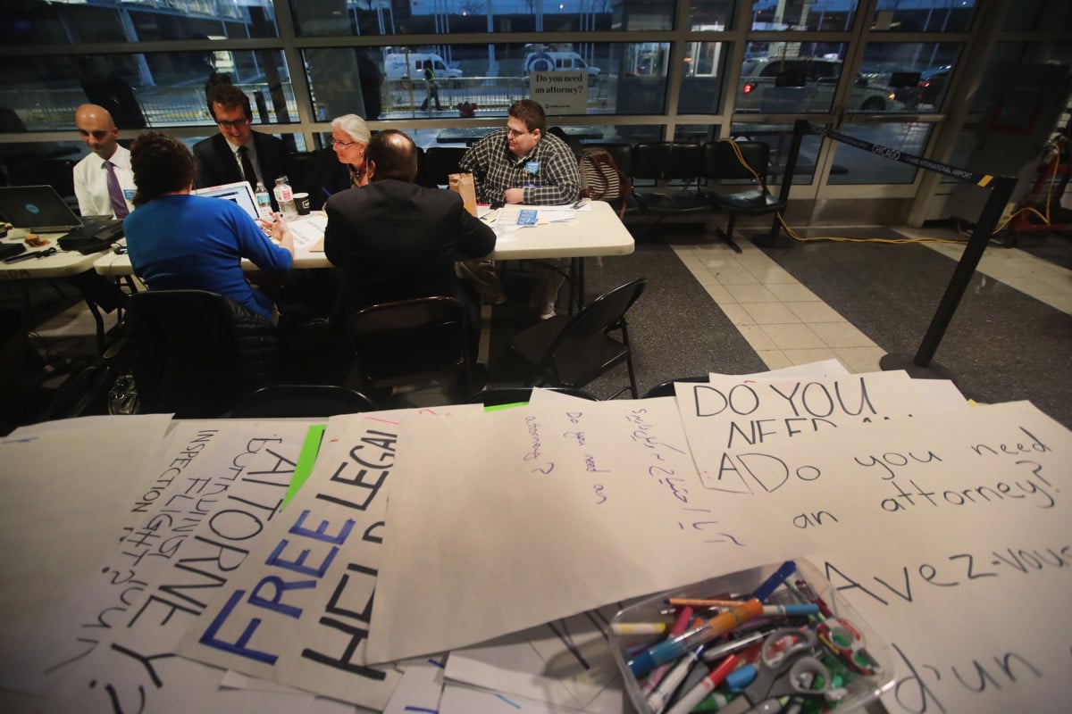 Volunteer attorneys and legal advisers listen to testimony from the travel ban case as they wait to assist travelers in the international terminal at O'Hare Airport on February 7, 2017 in Chicago, Illinois. A third of more than 500 pre-law students said the results of the 2016 election influenced their decision to become lawyers.