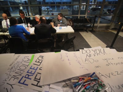 Volunteer attorneys and legal advisers listen to testimony from the travel ban case as they wait to assist travelers in the international terminal at O'Hare Airport on February 7, 2017 in Chicago, Illinois. A third of more than 500 pre-law students said the results of the 2016 election influenced their decision to become lawyers.