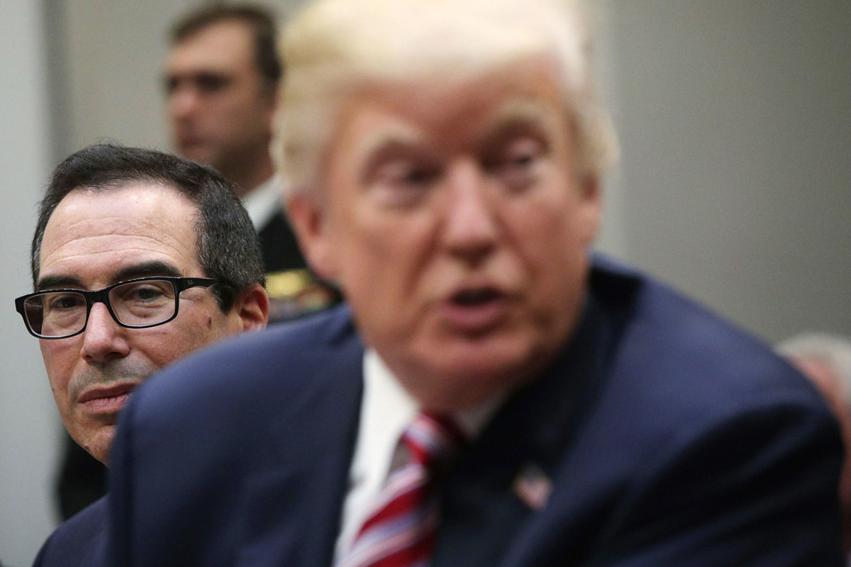 President Donald Trump speaks to business leaders as Secretary of the Treasury Steven Mnuchin looks on during a Roosevelt Room event October 31, 2017, at the White House in Washington, DC.