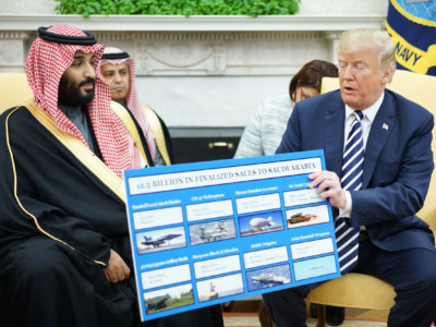 President Donald Trump holds a defence sales chart with Saudi Arabia's Crown Prince Mohammed bin Salman in the Oval Office of the White House on March 20, 2018, in Washington, DC.