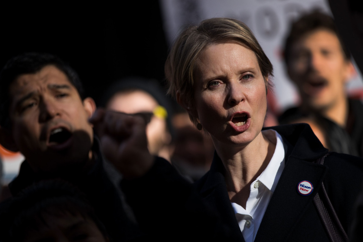 New York gubernatorial candidate Cynthia Nixon stands with activists as they rally against financial institutions' support of private prisons and immigrant detention centers, as part of a May Day protest near Wall Street in Lower Manhattan, May 1, 2018, in New York City.