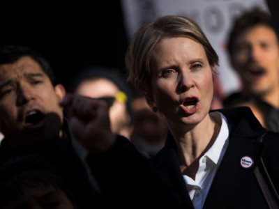 New York gubernatorial candidate Cynthia Nixon stands with activists as they rally against financial institutions' support of private prisons and immigrant detention centers, as part of a May Day protest near Wall Street in Lower Manhattan, May 1, 2018, in New York City.