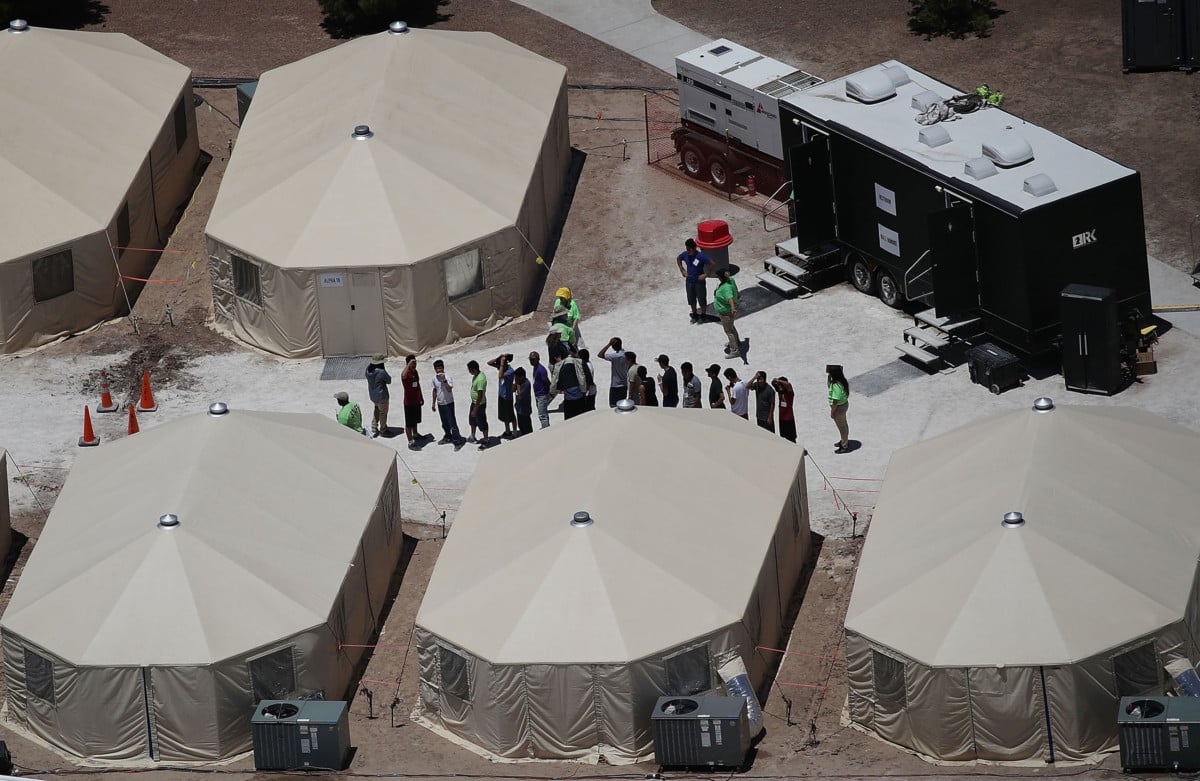 Children and workers are seen at a tent encampment built near the Tornillo Port of Entry on June 19, 2018, in Tornillo, Texas. The Trump administration is using the Tornillo tent facility to house immigrant children separated from their parents after they were caught entering the US under the administration's zero tolerance policy.