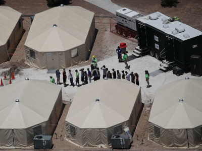 Children and workers are seen at a tent encampment built near the Tornillo Port of Entry on June 19, 2018, in Tornillo, Texas. The Trump administration is using the Tornillo tent facility to house immigrant children separated from their parents after they were caught entering the US under the administration's zero tolerance policy.