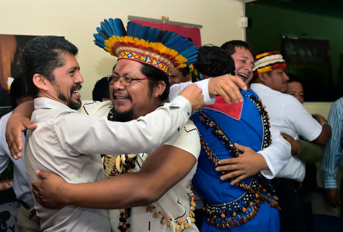 Pablo Fajardo, lawyer for the victims of environmental damage caused during Texaco's oil operations in the Ecuadoran Amazon (1964 to 1990), acquired by Chevron in 2001, celebrates with his clients, during a press conference in Quito, on July 11, 2018.
