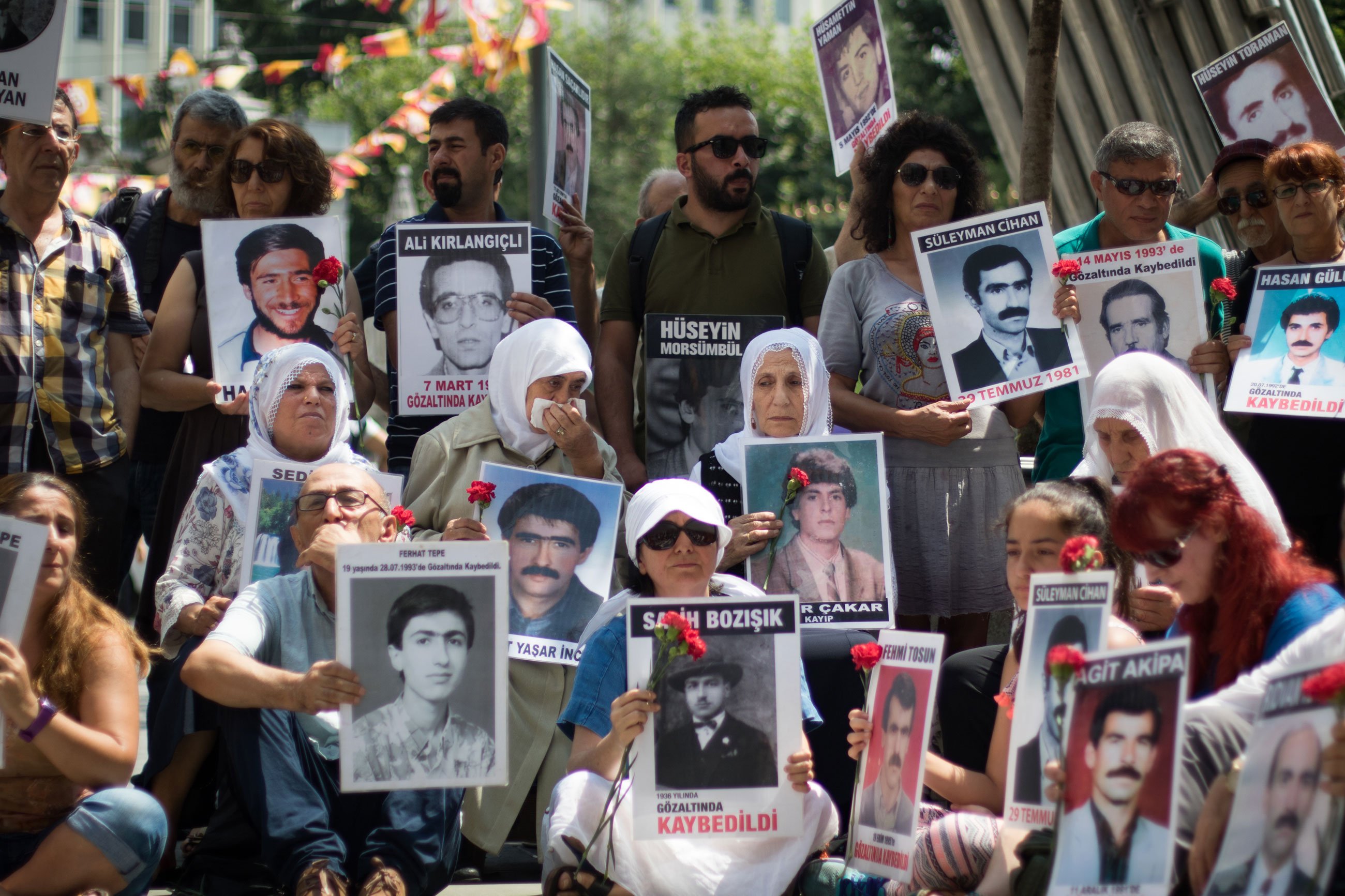 Photos of the disappeared among the crowd.