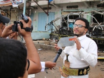 Yemeni journalist Ahmad Algohbary holds up a piece of the US-made bomb which killed 40 children last week.