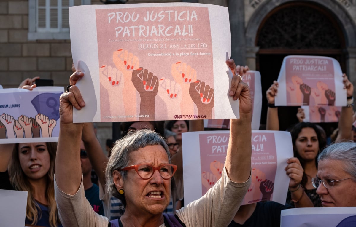 Protesters carry signs that read, "Enough of patriarchal justice," in Catalonia, Spain, June 21, 2018.