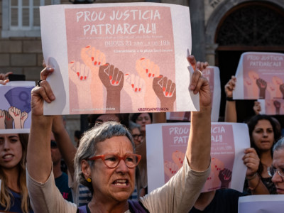 Protesters carry signs that read, "Enough of patriarchal justice," in Catalonia, Spain, June 21, 2018.