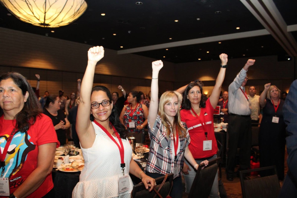 Los Angeles educators raise their fists the All in For Respect Conference in August 2018.