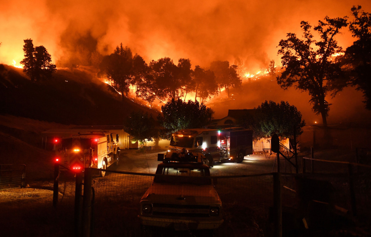 Firefighters conduct a controlled burn to defend houses against flames from the Ranch Fire, part of the Mendocino Complex Fire, as it continues to spreads toward the town of Upper Lake, California, on August 2, 2018.