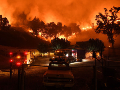 Firefighters conduct a controlled burn to defend houses against flames from the Ranch Fire, part of the Mendocino Complex Fire, as it continues to spreads toward the town of Upper Lake, California, on August 2, 2018.