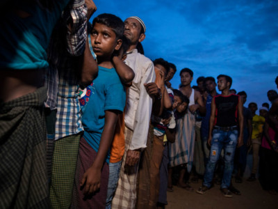 Rohingya wait in line for humanitarian aid in Kutupalong camp August 27, 2018 in Kutupalong, Cox's Bazar, Bangladesh.