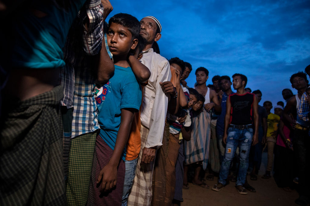 Rohingya wait in line for humanitarian aid in Kutupalong camp August 27, 2018 in Kutupalong, Cox's Bazar, Bangladesh.