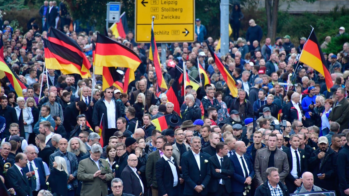 Demonstrators hold flags of Germany during a protest organized by the right-wing populist "Pro-Chemnitz" movement, the far-right Alternative for Germany Party and the anti-Islam Pegida movement on September 1, 2018, in Chemnitz, eastern Germany.
