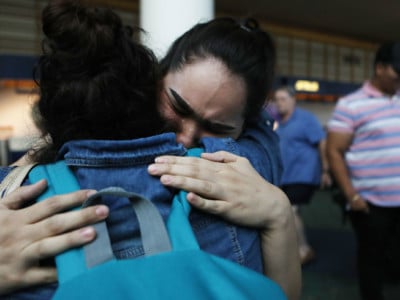 An immigrant who identified herself as Vioney (left), recently released after spending six months in an Immigration and Customs Enforcement detention jail, is hugged by her daughter Citaly (center) while being reunited with family members at the Portland International Airport on September 2, 2018, in Portland, Oregon. Vioney, originally from Mexico, crossed the San Ysidro Port of Entry with three of her four children in February and asked US authorities for asylum. She was separated from her three children the same day and detained in California until August 31.