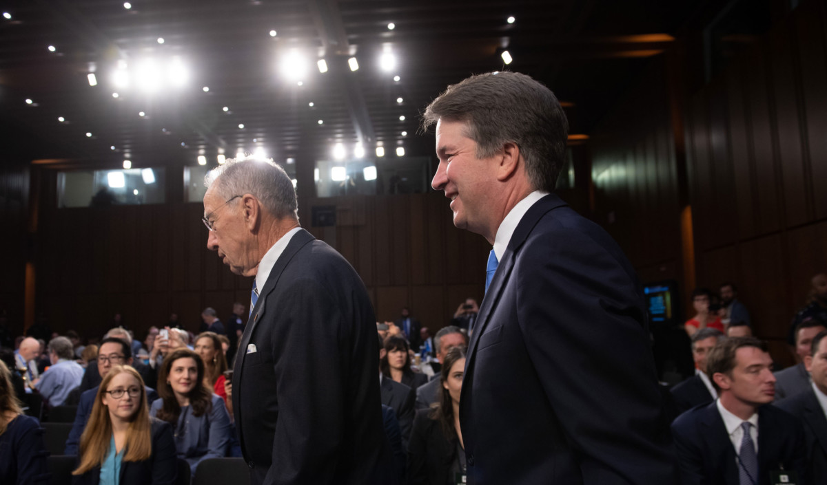 Supreme Court nominee Brett Kavanaugh arrives alongside Sen. Chuck Grassley on the second day of his confirmation hearing in front of the Senate on Capitol Hill in Washington, DC, on September 5, 2018.