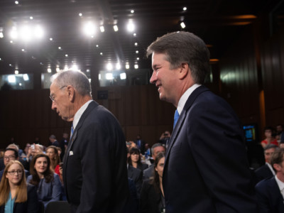 Supreme Court nominee Brett Kavanaugh arrives alongside Sen. Chuck Grassley on the second day of his confirmation hearing in front of the Senate on Capitol Hill in Washington, DC, on September 5, 2018.