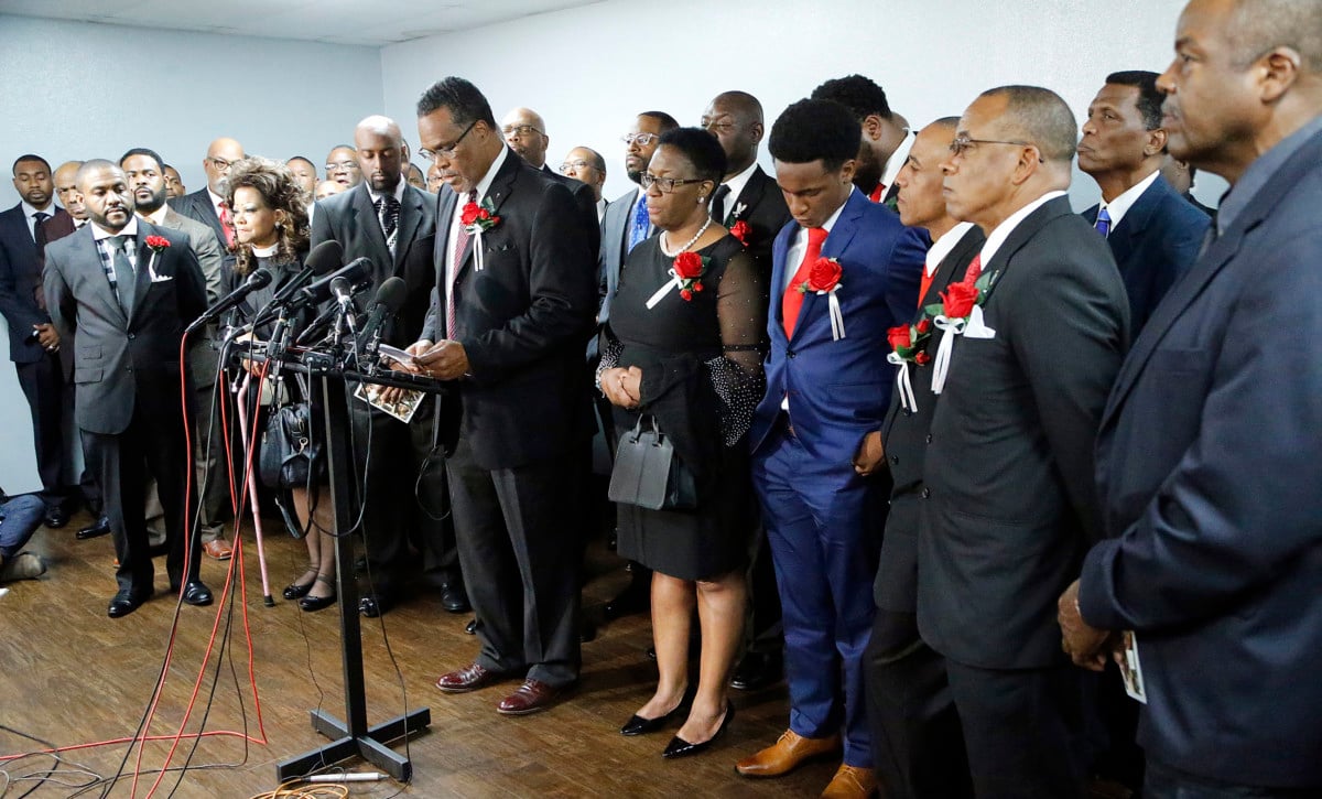 Church members stand with the family of Botham Shem Jean at a press conference after the funeral service at Greenville Avenue Church of Christ on September 13, 2018, in Richardson, Texas.