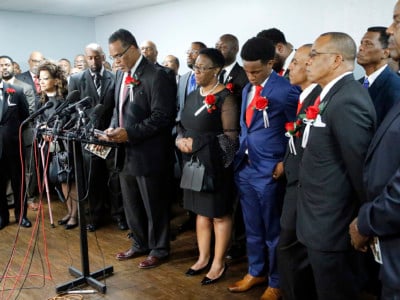 Church members stand with the family of Botham Shem Jean at a press conference after the funeral service at Greenville Avenue Church of Christ on September 13, 2018, in Richardson, Texas.