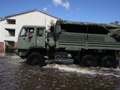 A North Carolina National Guard truck drives through flood waters caused by Hurricane Florence around an apartment complex on September 18, 2018, in Spring Lake, North Carolina.