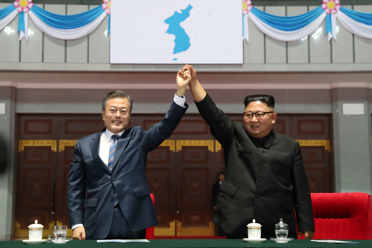 North Korean leader Kim Jong Un (right) and South Korean President Moon Jae-in (left) gesture as they watch a gymnastic and artistic performance at the May Day Stadium on September 19, 2018, in Pyongyang, North Korea.