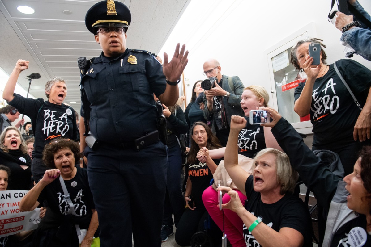 US Capitol Police prepare to arrest demonstrators as they protest against the nomination of Judge Brett Kavanaugh to be a Supreme Court Justice outside of the office of US Sen. Susan Collins (R-Maine) on Capitol Hill in Washington, DC, September 24, 2018.