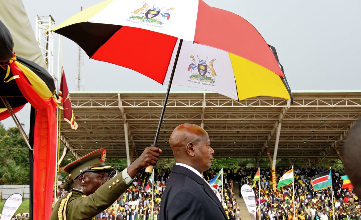 Uganda's President Yoweri Museveni stands under an umbrella during his swearing-in ceremony in Kampala on May 12, 2016.