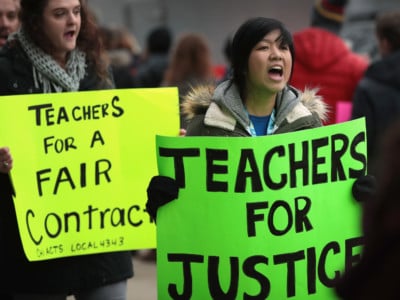 Unionized teachers with the ASPIRA Charter School Network rally outside an ASPIRA high school to convince the company's management to come to terms on a contract on March 9, 2017, in Chicago, Illinois.