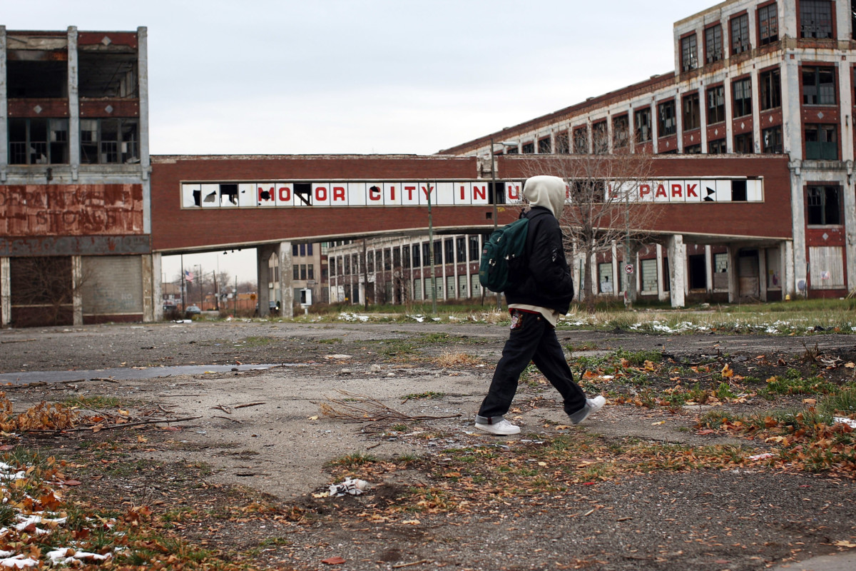 A person walks past the remains of the Packard Motor Car Company, which ceased production in the late 1950s, November 19, 2008, in Detroit, Michigan.