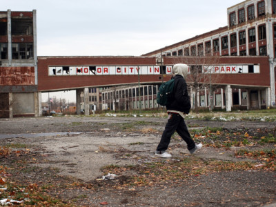 A person walks past the remains of the Packard Motor Car Company, which ceased production in the late 1950s, November 19, 2008, in Detroit, Michigan.