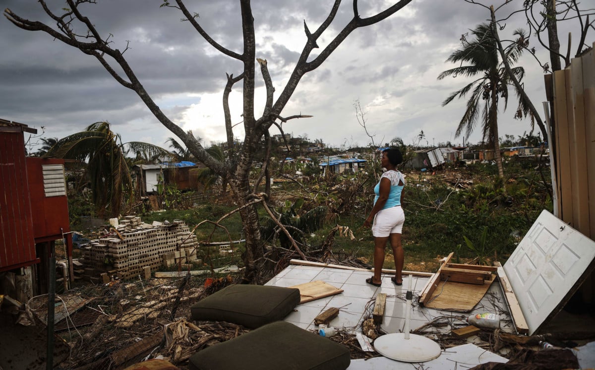 Resident Mirian Medina stands on her property about two weeks after Hurricane Maria swept through the island on October 5, 2017, in San Isidro, Puerto Rico.