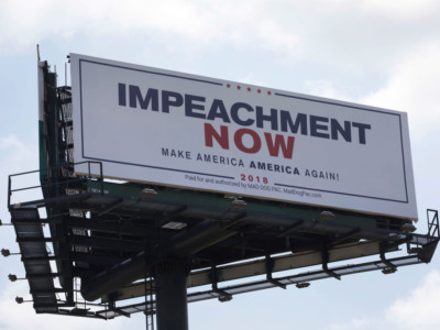 A billboard reading: 'Impeachment Now Make America America Again!' calling for President Donald Trump's impeachment is seen along a street leading to Mar-A-Lago on March 19, 2018, in West Palm Beach, Florida.