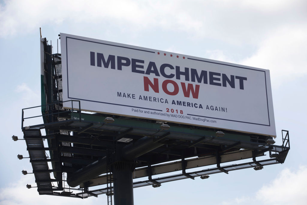 A billboard reading: 'Impeachment Now Make America America Again!' calling for President Donald Trump's impeachment is seen along a street leading to Mar-A-Lago on March 19, 2018, in West Palm Beach, Florida.