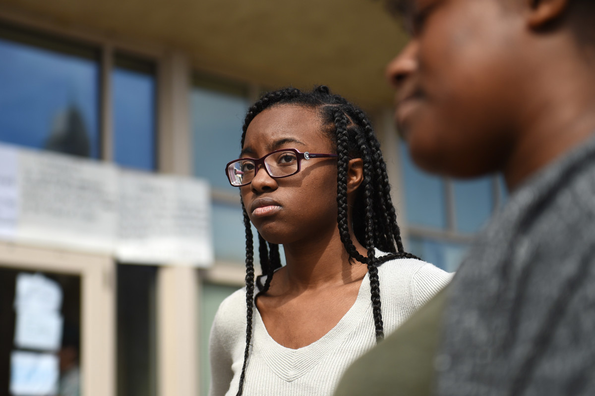 Freshman Maya McCollum talks to reporters outside Howard University's administration building in Washington, DC, where she and fellow students are sitting-in to protest the university policies, tuition hikes and neglect of student affairs on March 31, 2018.