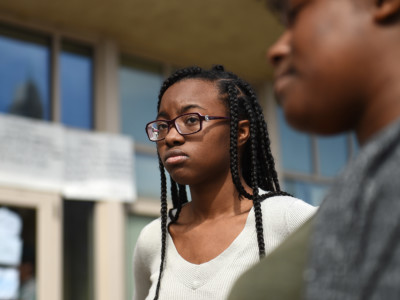 Freshman Maya McCollum talks to reporters outside Howard University's administration building in Washington, DC, where she and fellow students are sitting-in to protest the university policies, tuition hikes and neglect of student affairs on March 31, 2018.