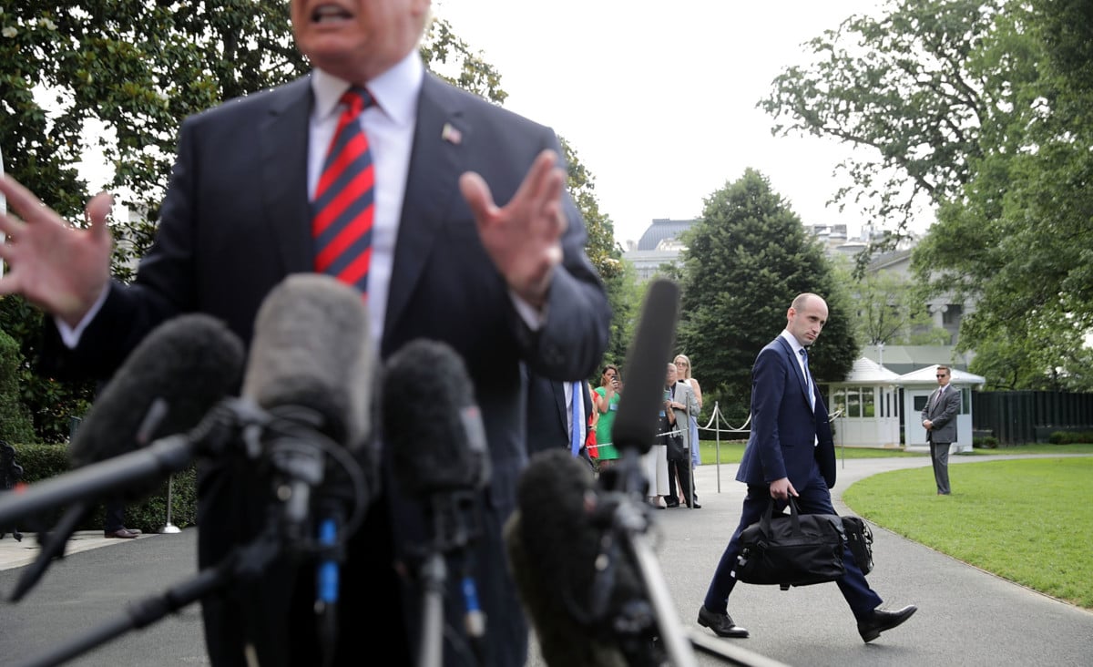 Senior Adviser Stephen Miller walks behind President Trump as he talks to reporters before they depart the White House on June 8, 2018, in Washington, DC. Miller and a group of like-minded aides are pressing ahead with policies designed to drastically reduce the number of people entering the US.